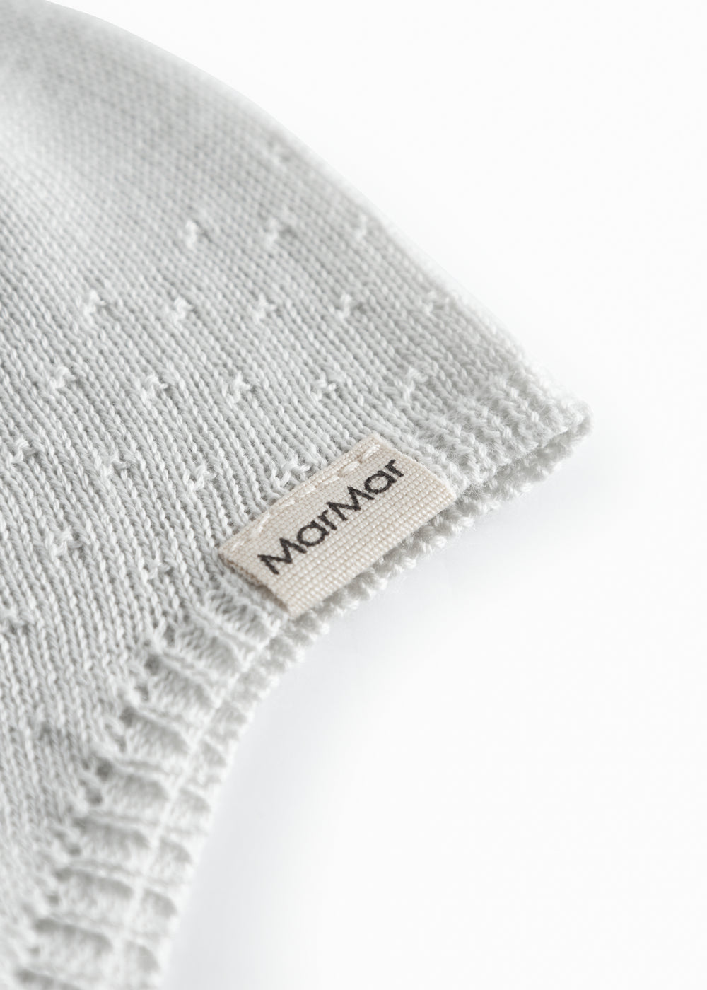 Light green baby hat with a snap closure