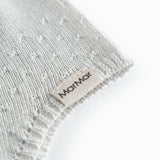 Light green baby hat with a snap closure