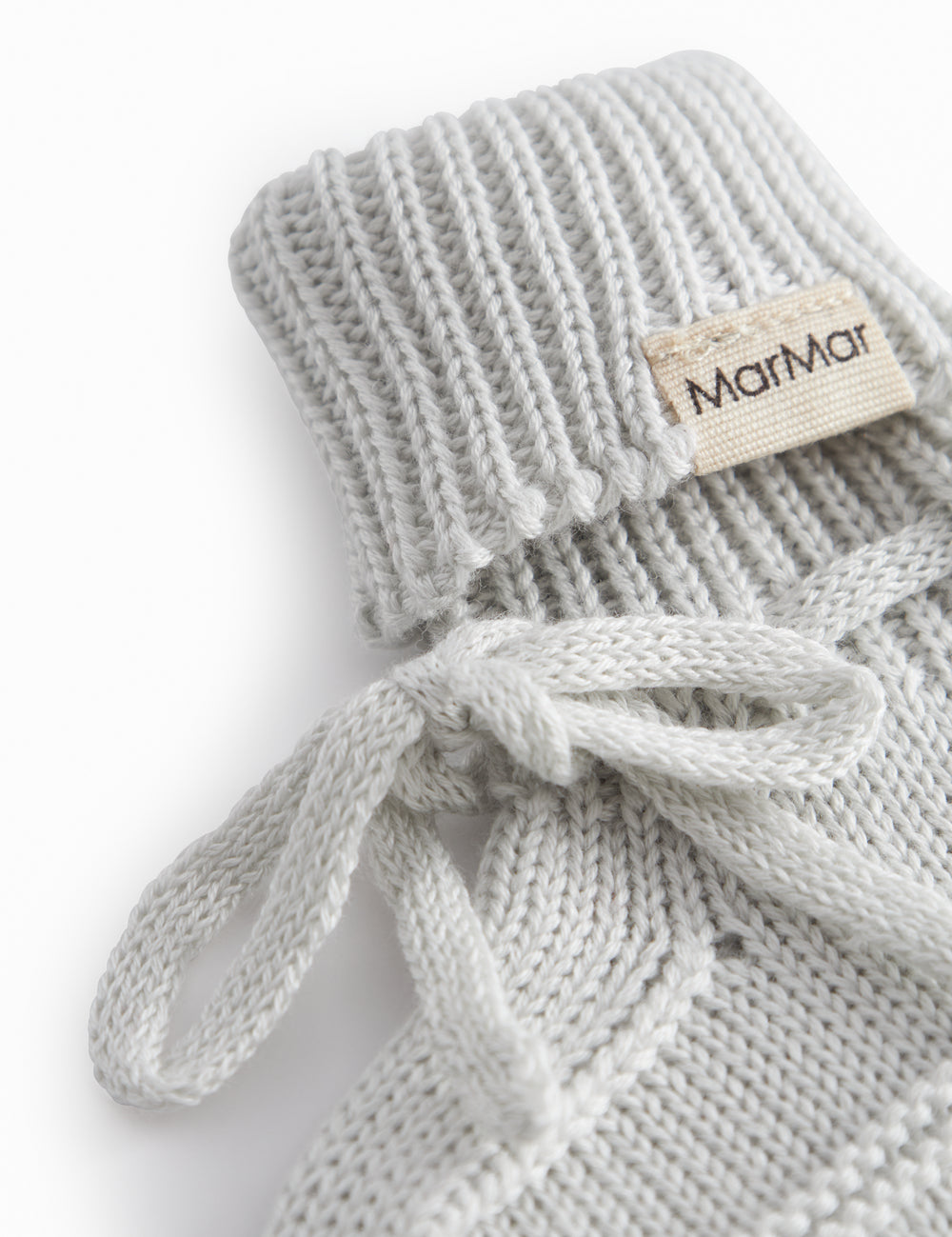 Green striped baby food with a ribbed edge and tie.