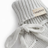 Green striped baby food with a ribbed edge and tie.