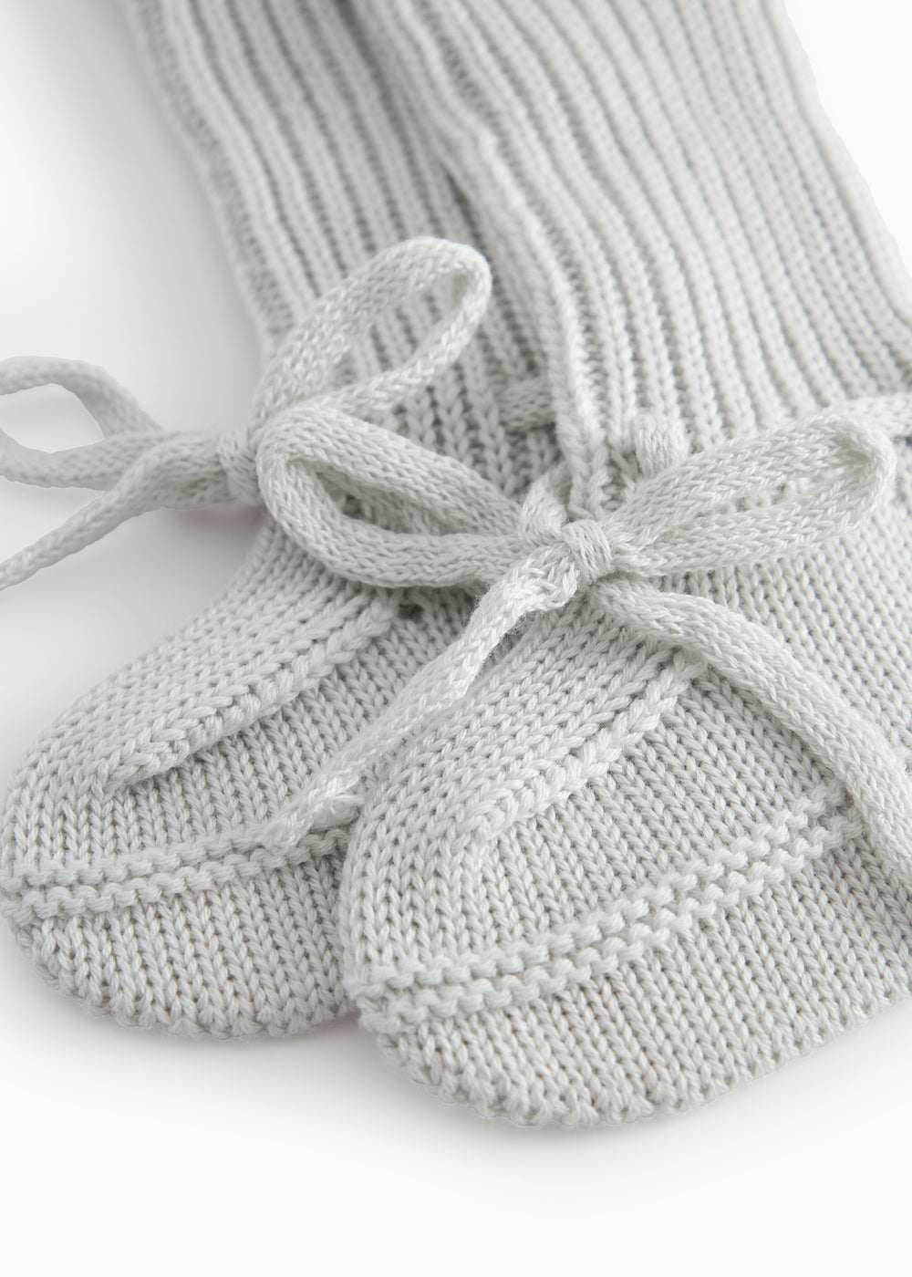 Green striped baby food with a ribbed edge and tie.