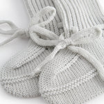 Green striped baby food with a ribbed edge and tie.