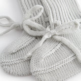 Green striped baby food with a ribbed edge and tie.