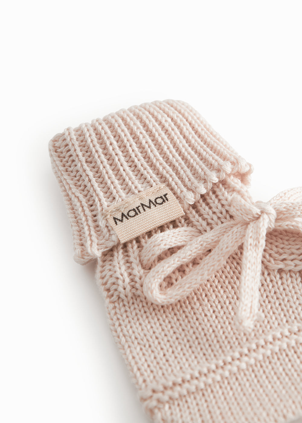 Red baby food in bright red with a ribbed edge and a tie.