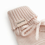 Red baby food in bright red with a ribbed edge and a tie.