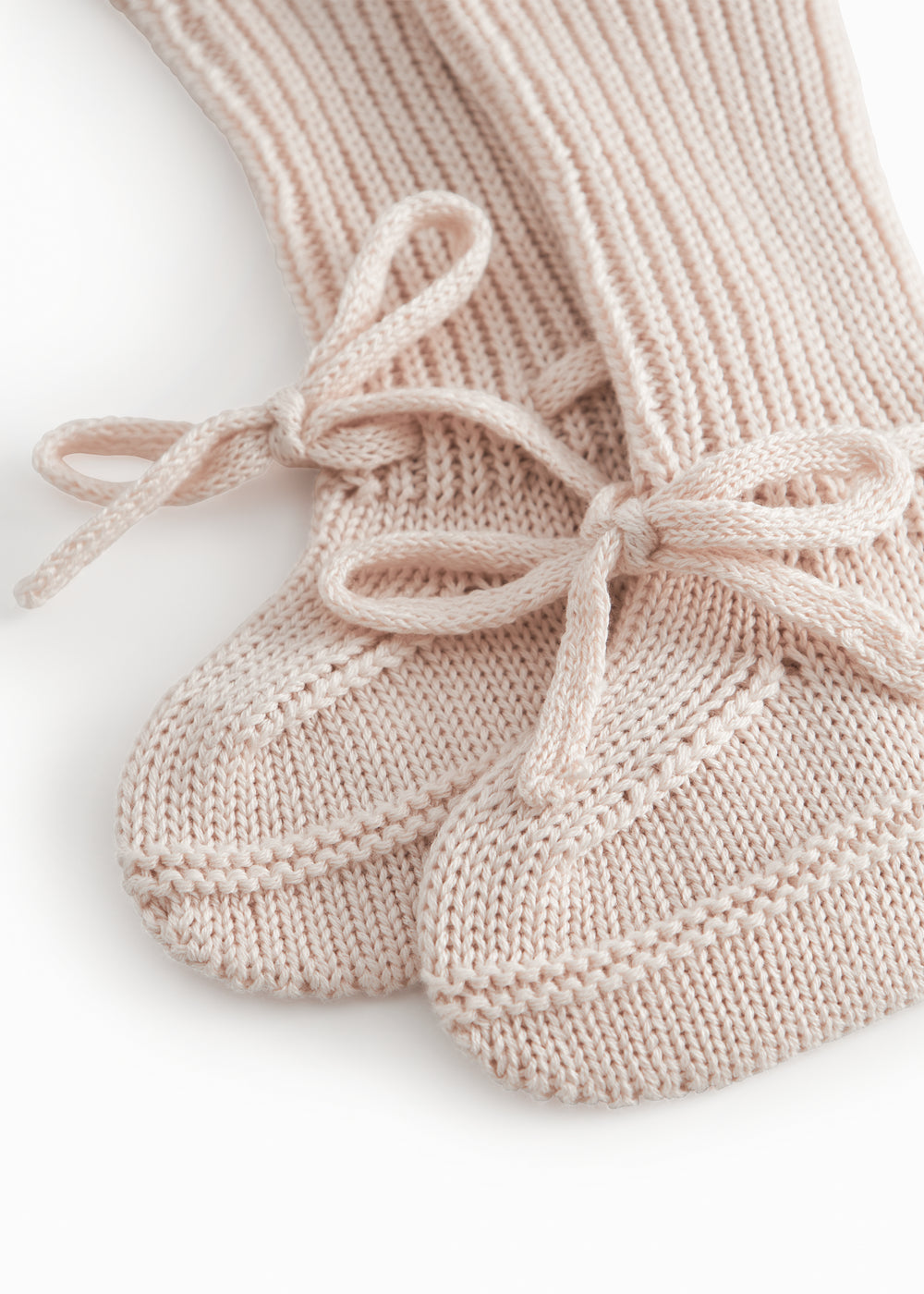 Red baby food in bright red with a ribbed edge and a tie.