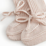 Red baby food in bright red with a ribbed edge and a tie.