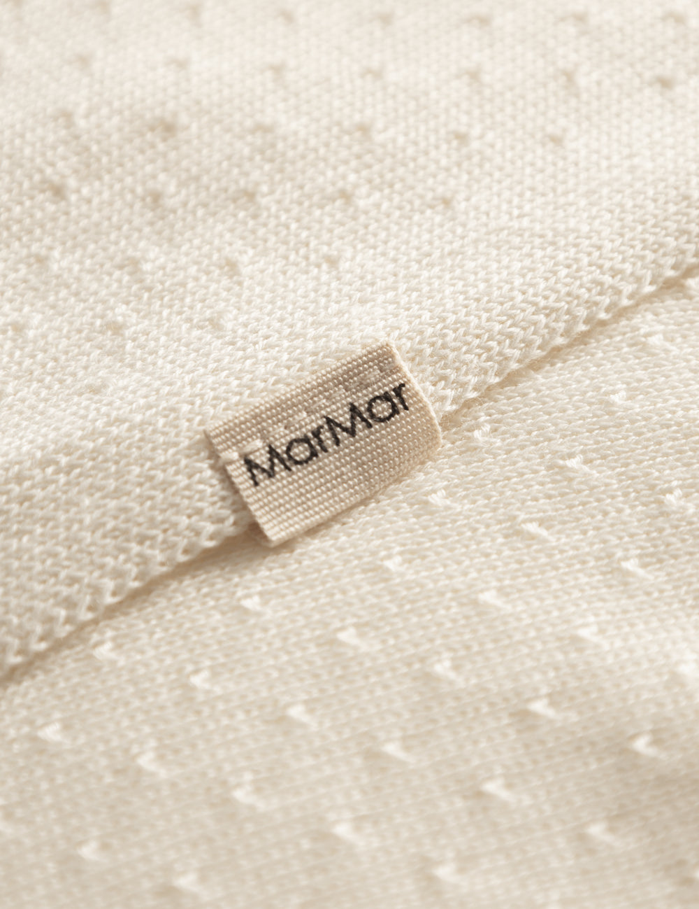 White baby blanket with a hole pattern