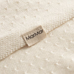 White baby blanket with a hole pattern