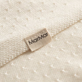 White baby blanket with a hole pattern