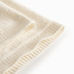 White baby blanket with a hole pattern