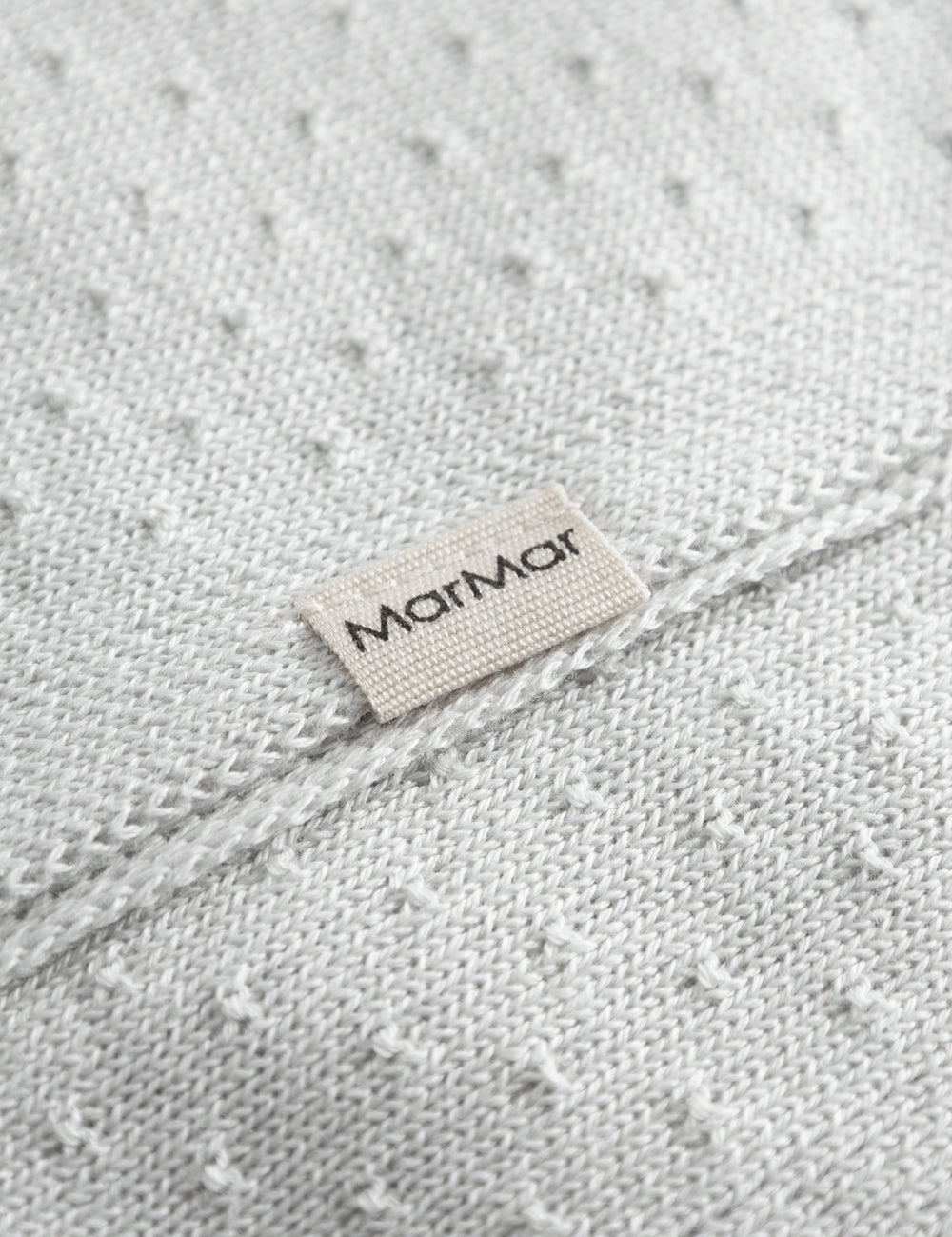 Green baby blanket with a hole pattern