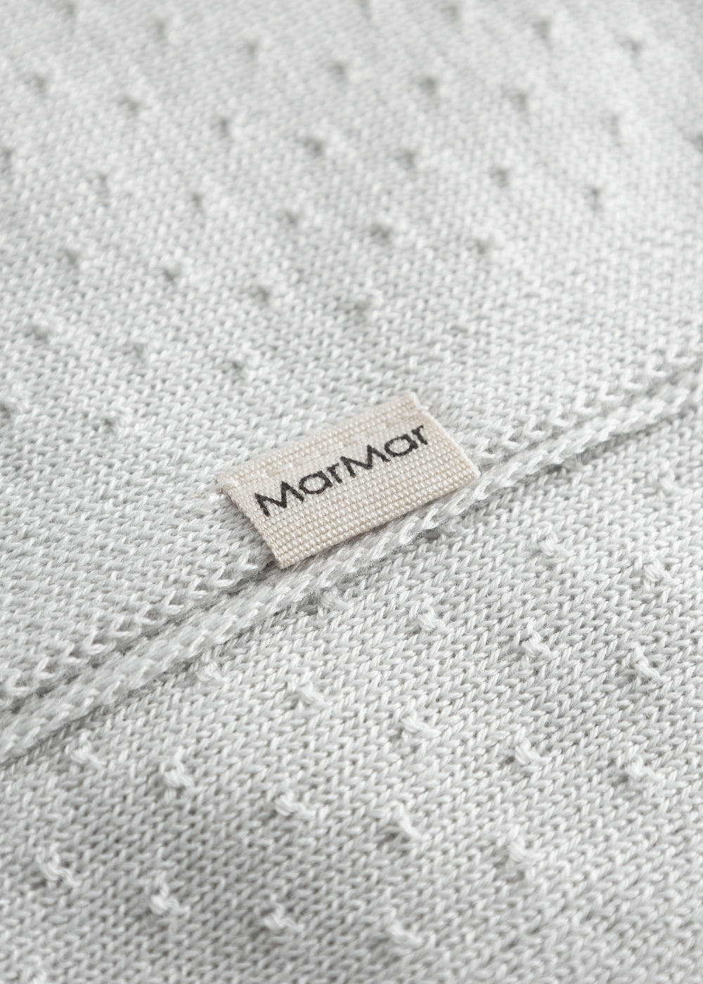 Green baby blanket with a hole pattern