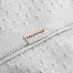 Green baby blanket with a hole pattern