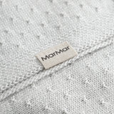 Green baby blanket with a hole pattern