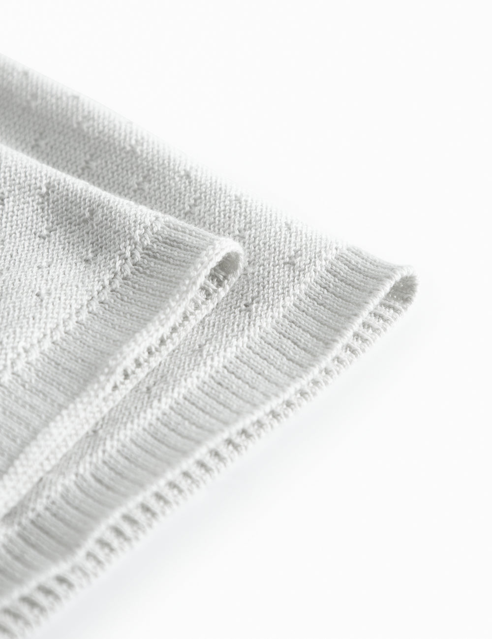 Green baby blanket with a hole pattern