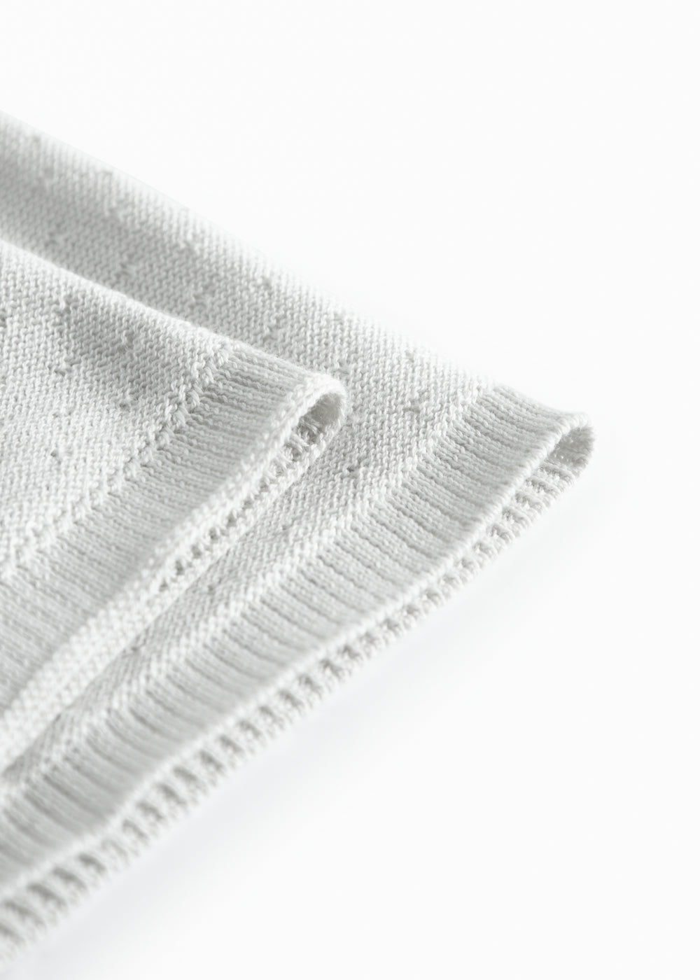 Green baby blanket with a hole pattern