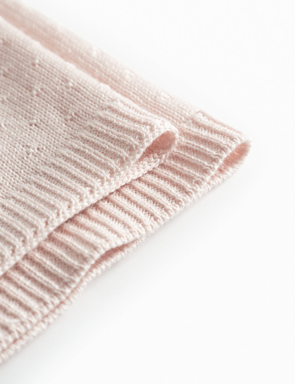 Red baby blanket with a hole pattern