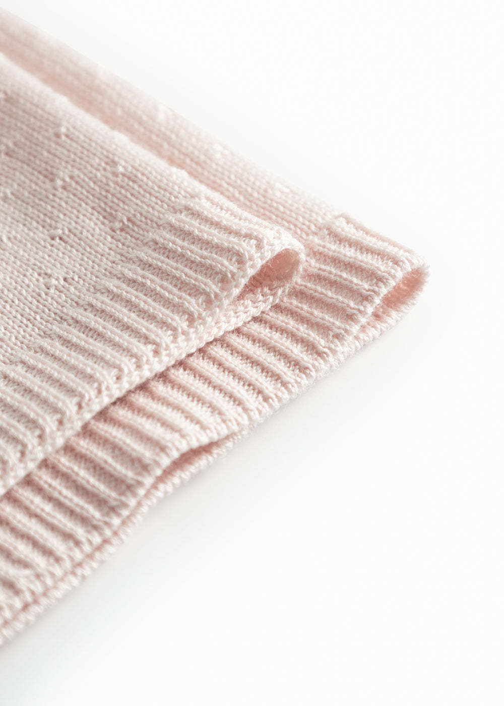 Red baby blanket with a hole pattern