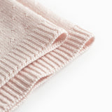 Red baby blanket with a hole pattern