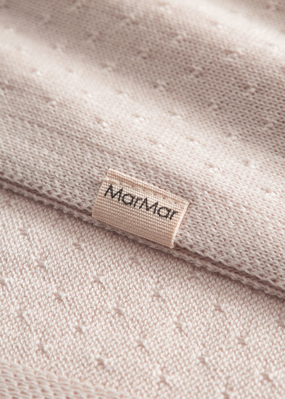 Red baby blanket with a hole pattern