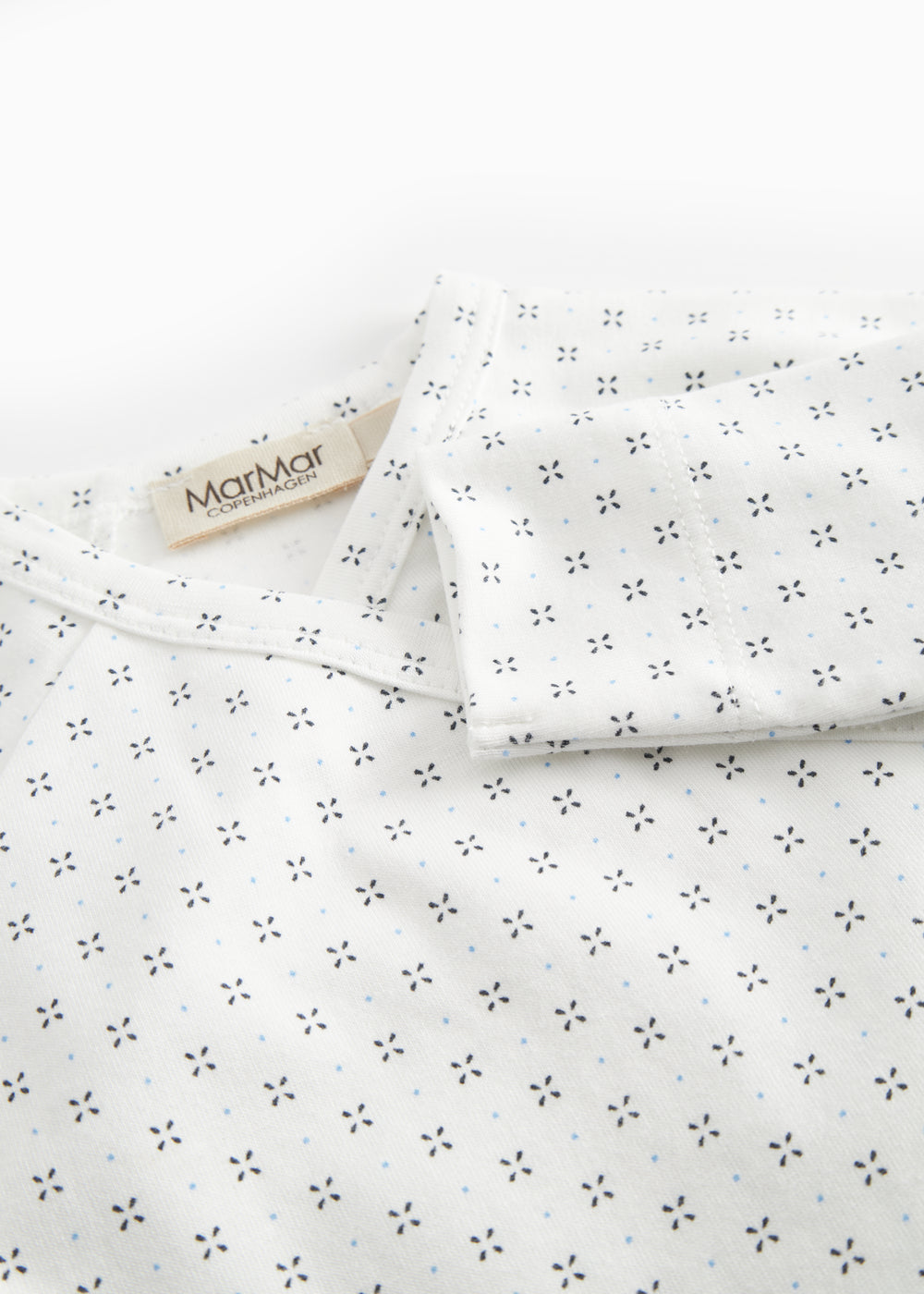 White baby bodysuit with fine pattern