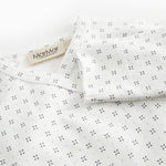 White baby bodysuit with fine pattern
