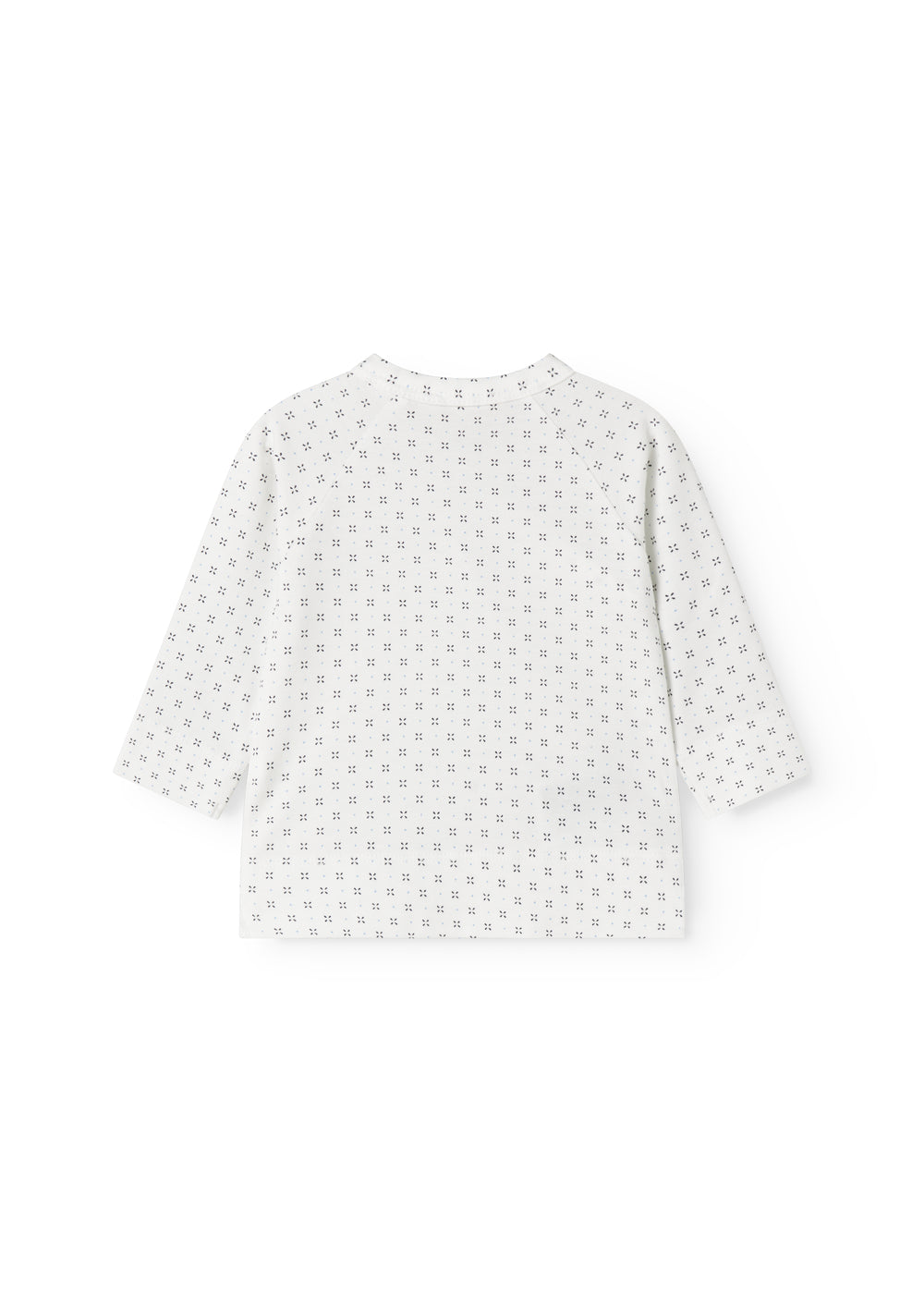 Hvid babybluse med slå-om lukning og fint mønster