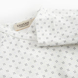 White baby blouse with wrap closure and fine pattern