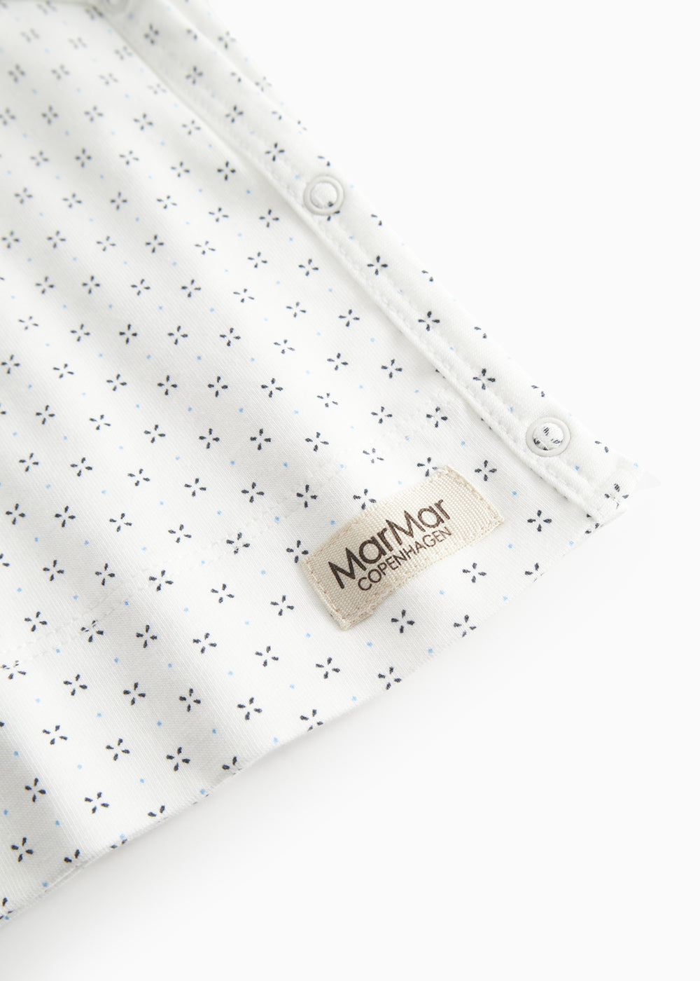 White baby blouse with wrap closure and fine pattern