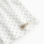 White baby blouse with wrap closure and fine pattern