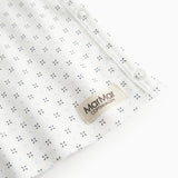White baby blouse with wrap closure and fine pattern