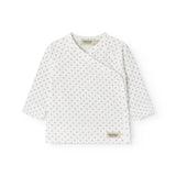 White baby blouse with wrap closure and fine pattern