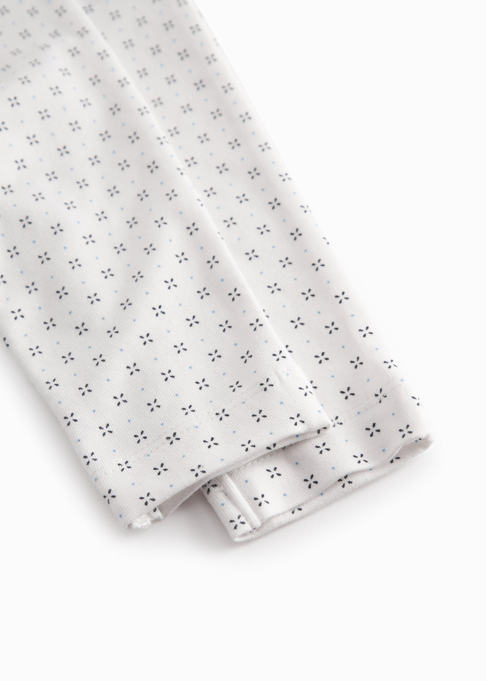 White baby trousers with fine pattern
