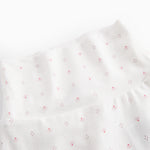 White baby trousers with feet and a fine floral pattern