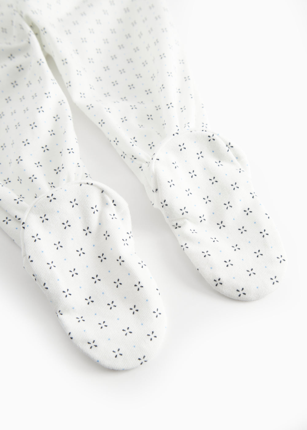White baby trousers with feet and a fine pattern