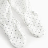 White baby trousers with feet and a fine pattern