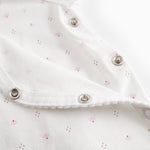 White baby romper without legs with fine floral pattern