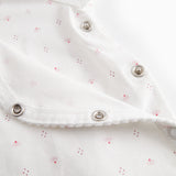 White baby romper without legs with fine floral pattern