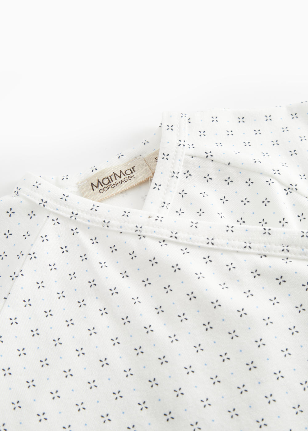 White baby sleepsuit without legs with fine pattern