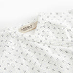 White baby sleepsuit without legs with fine pattern