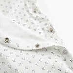 White baby sleepsuit without legs with fine pattern