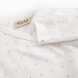 White baby all-in-one with feet in fine floral pattern