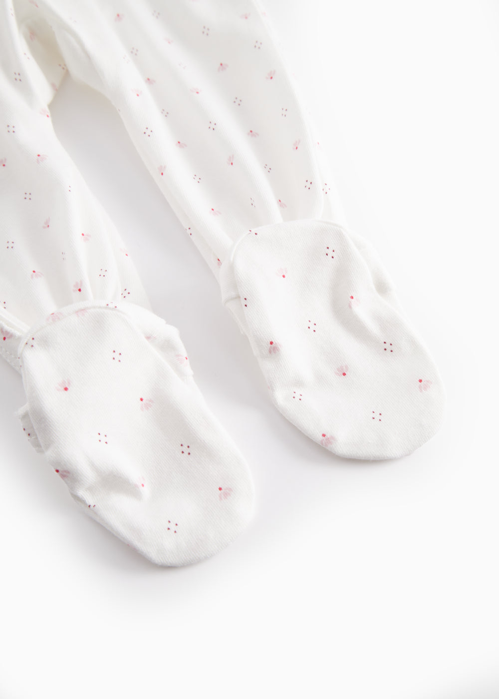 White baby all-in-one with feet in fine floral pattern