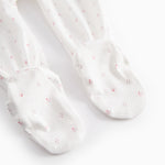 White baby all-in-one with feet in fine floral pattern