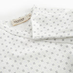White baby all-in-one with feet in fine pattern