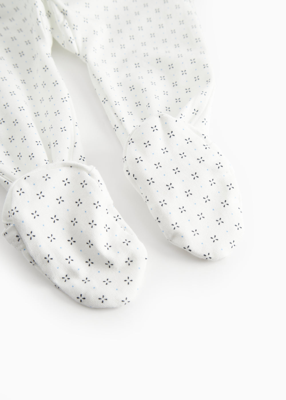 White baby all-in-one with feet in fine pattern