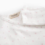 White baby all-in-one with wrap-around closure and small flowers