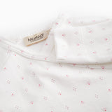 White baby all-in-one with wrap-around closure and small flowers