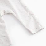 White baby all-in-one with wrap-around closure and small flowers